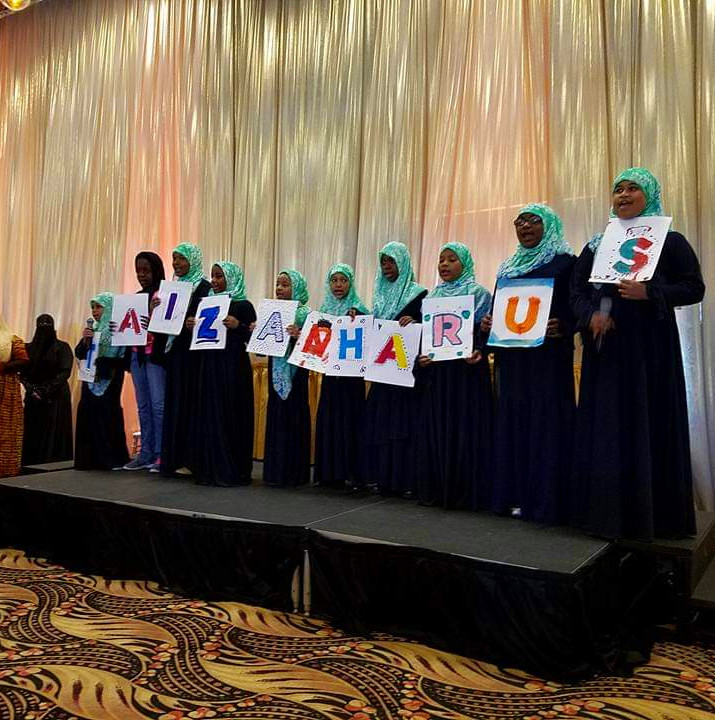 Alimah Scouts banquet holding up letters 2017